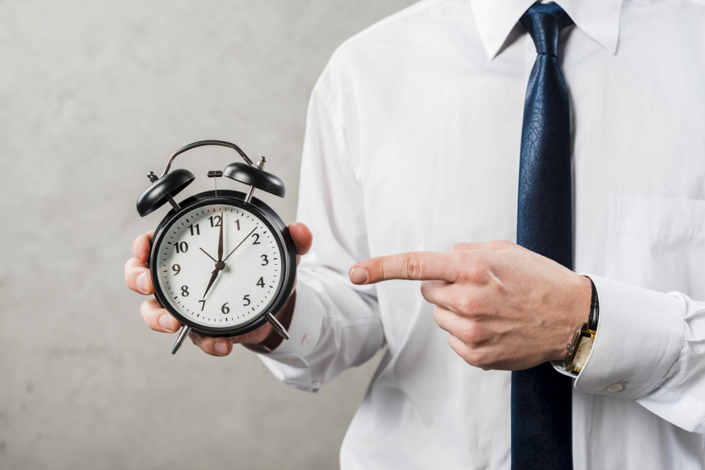 close-up-businessman-pointing-finger-time-against-grey-wall-(1).jpg